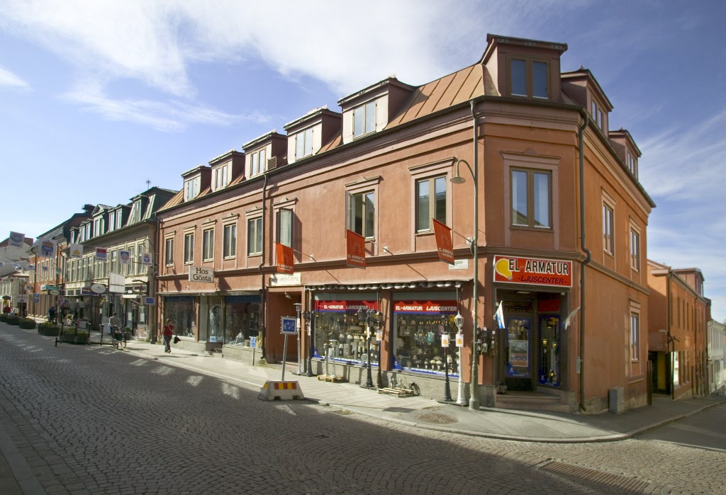 Byggnad i 3 våningar, butiker på markplan och bostäder på våningarna ovanför. 