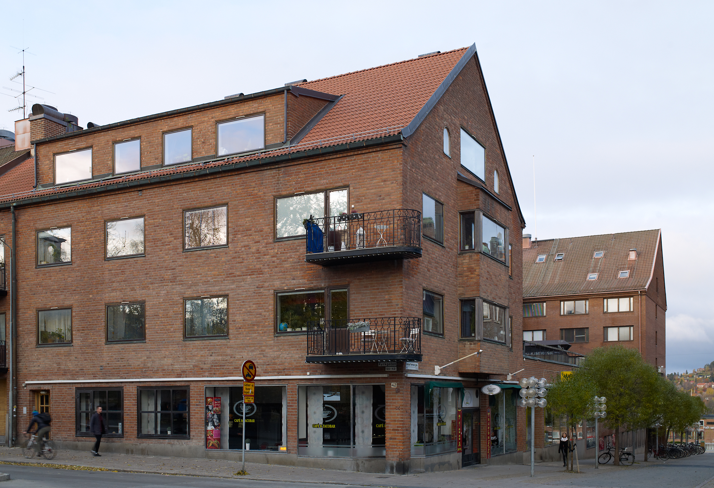 Tegelbyggnad i 4 våningar. Balkong på våning två och tre.