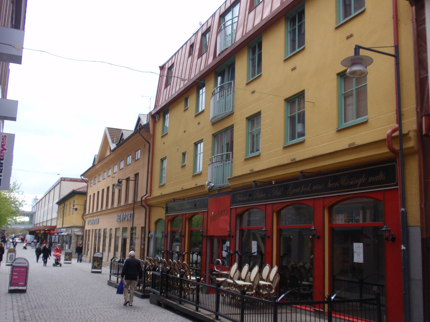 Gul byggnad i 4 våningar med franska balkonger. 