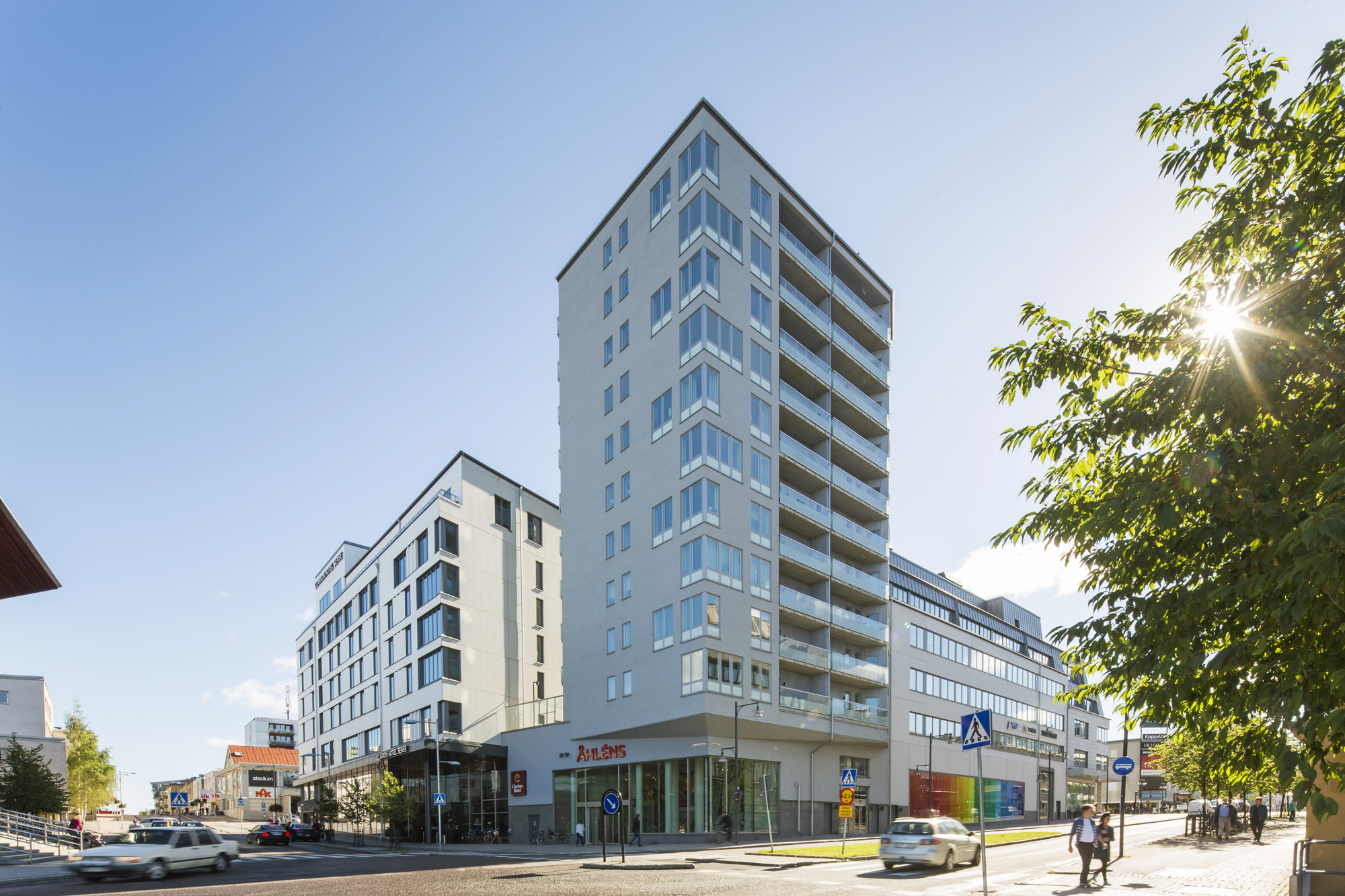 Tre vita byggnader. Den mittersta har 11 våningar med balkonger, de på varsin sida är lägre med 7 r
